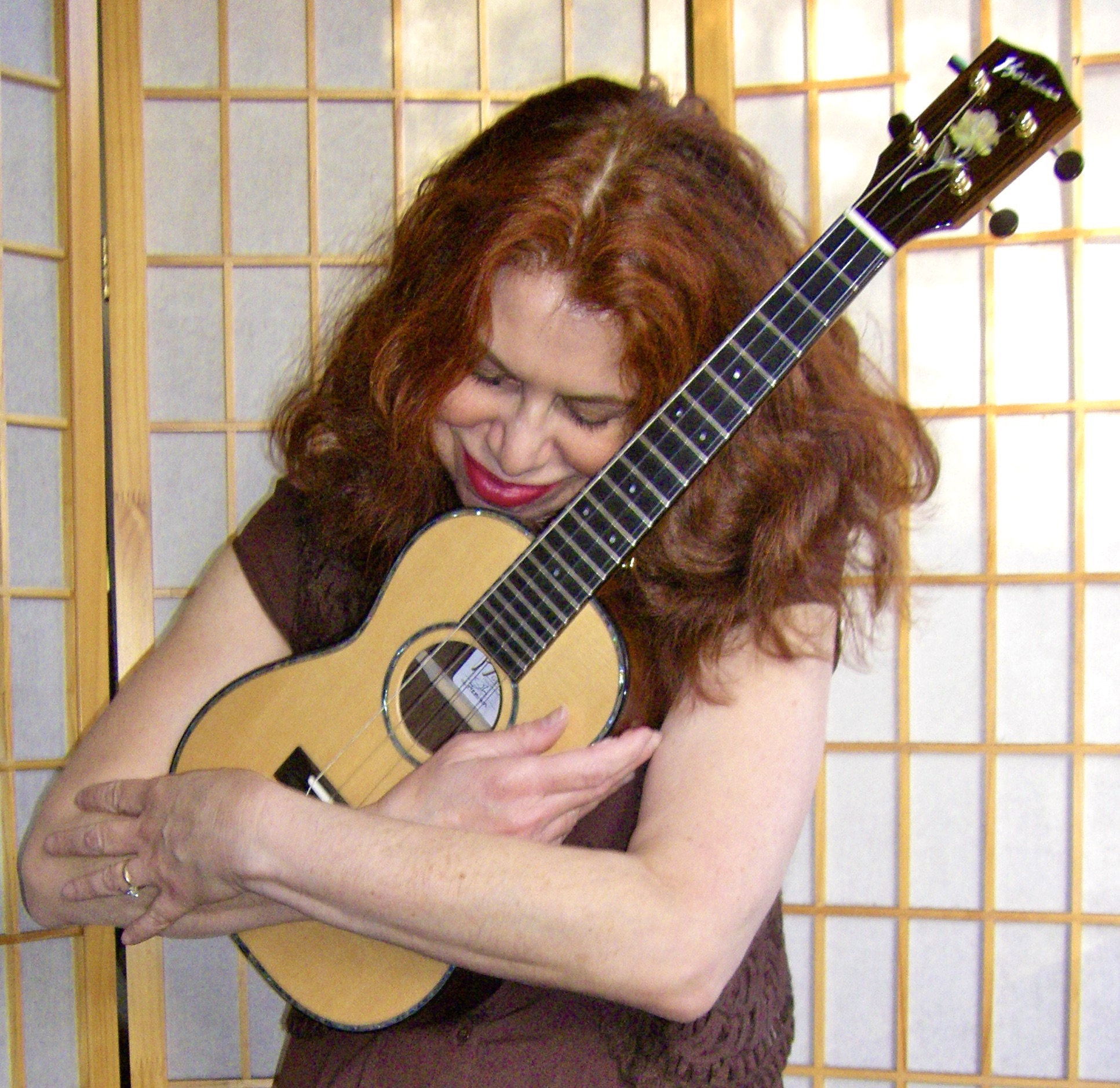 a woman hugging a ukulele